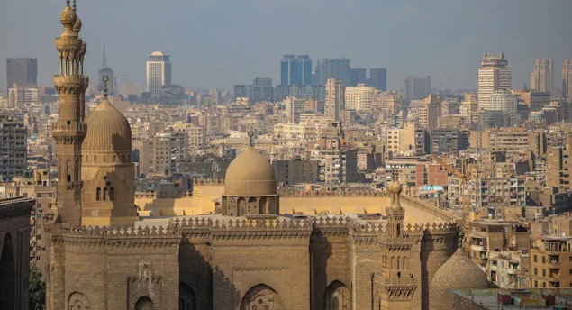 Residential apartment buildings beyond a mosque, viewed from the Citadel of Saladin, in Cairo