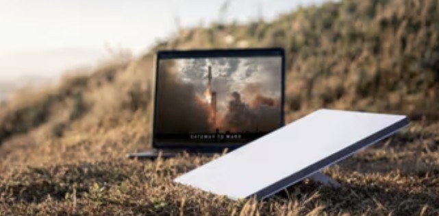 A marketing image of the new Starlink Mini next to a laptop