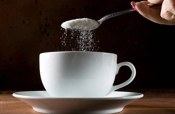 Image of Sugar being poured into a cup