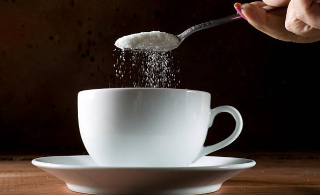 Image of Sugar being poured into a cup