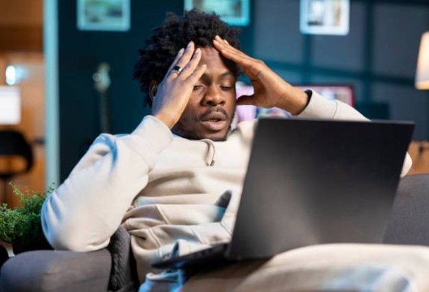 Image of a stressed person holding his head out of frustration